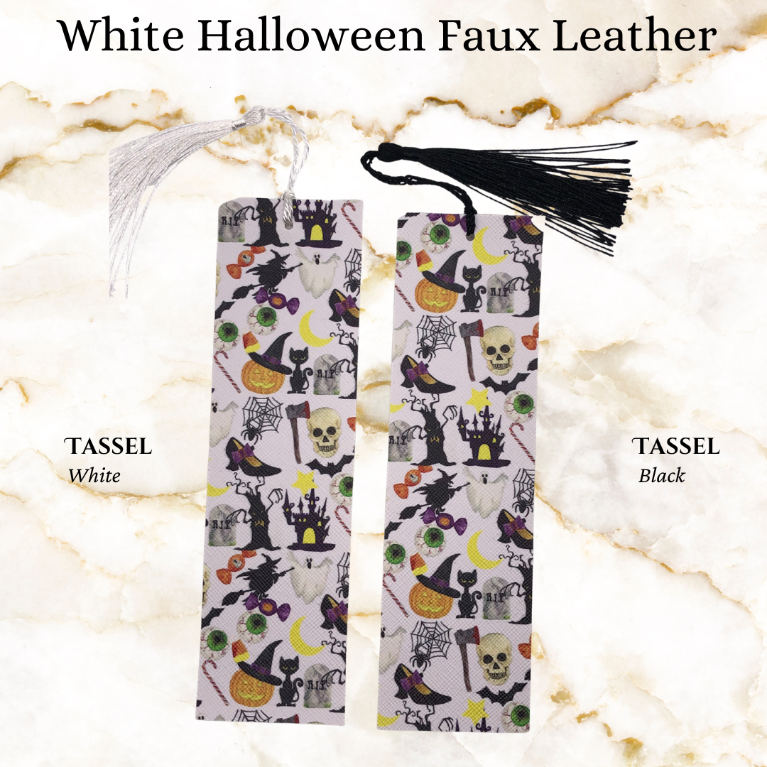 White background with random halloween image faux leather bookmark - 1 black tassel and 1 white tassel
