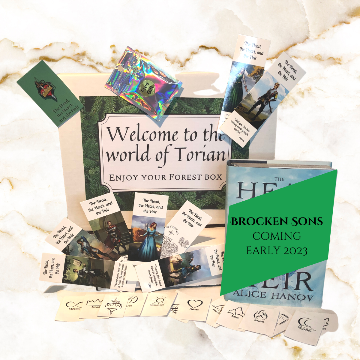 Image of Forest box - includes photos of the items in the box - including signed hardcover book 2, enamal pin, set of 8 bookmarks, set of 13 stickers, 2 small surprises