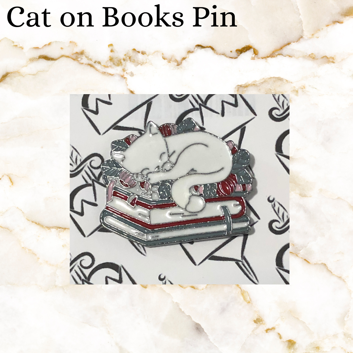 Book pin - white cat sleeping on flowers on a stack of 2 books -  red, grey and white colours