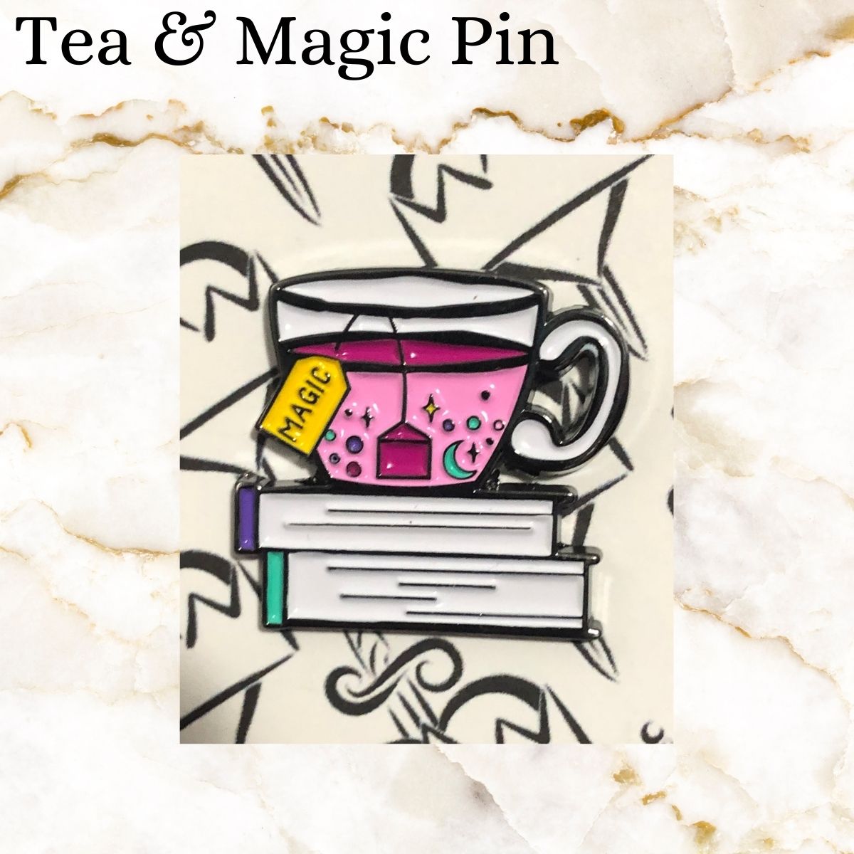 Book pin - of two books with a cup of pink tea and tea bag saying magic on it