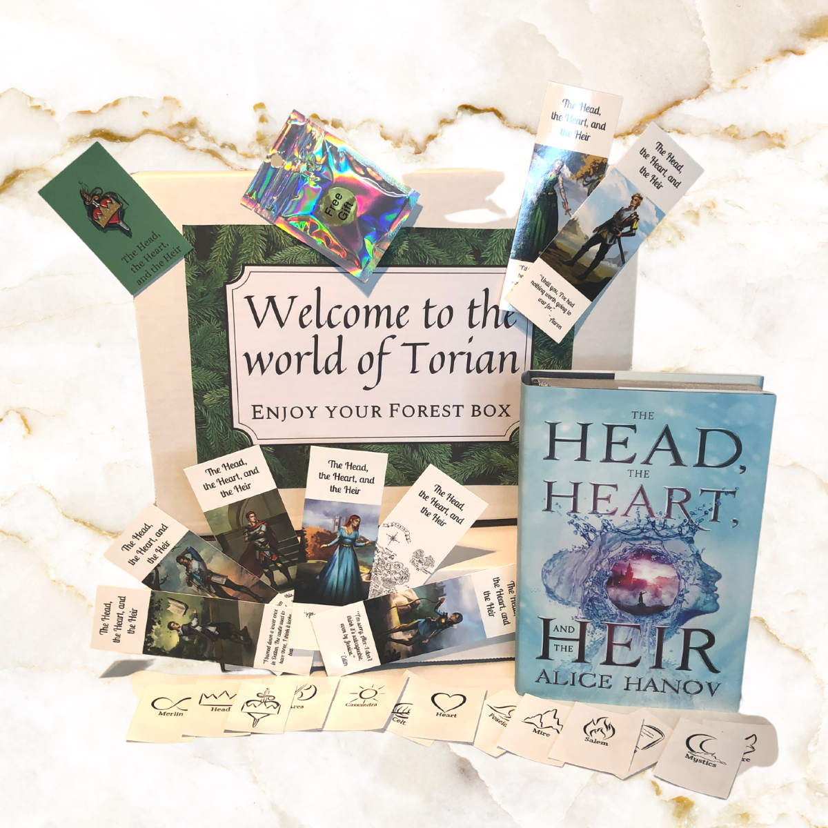 Image of Forest box - includesphotos of the items in the box - including signed hardcover book 1, enamal pin, set of 8 bookmarks, set of 13 stickers, 2 small surprises